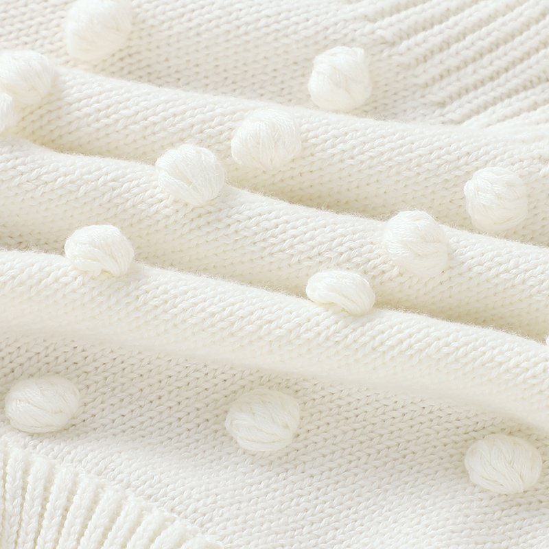 Ärmelloser Baby-Strickstrampler mit Plüsch-Bommeln