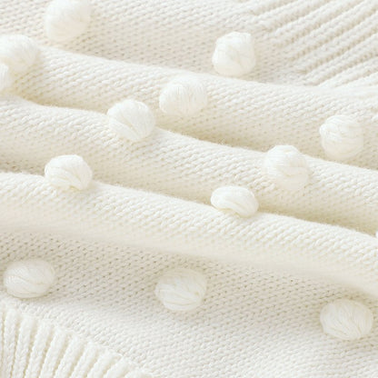 Ärmelloser Baby-Strickstrampler mit Plüsch-Bommeln