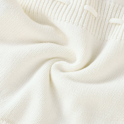 Ärmelloser Baby-Strickstrampler mit Plüsch-Bommeln